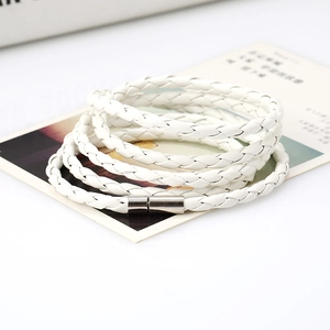 Close-up of white multi-layer braided PU leather bracelet with silver magnetic metal clasp