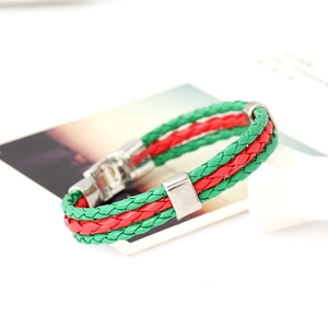 Detail of woven green and red leather bracelet with silver metal clasp and sliders