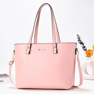 Elegant light pink leather tote bag with gold hardware and versatile shoulder strap