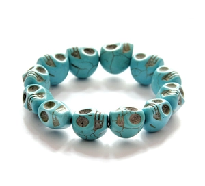 Detailed close-up of turquoise skull beaded bracelet with vintage black crackle patterns