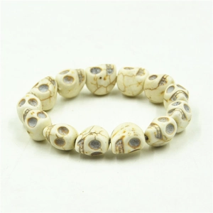 Detailed close-up of skull beads bracelet featuring vintage white turquoise texture