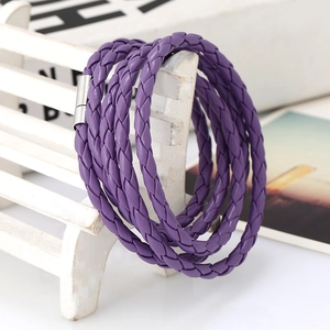 Detailed shot of purple multi-layer braided bracelet with silver magnetic clasp on white bench