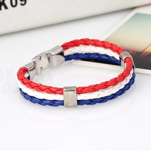 Detail of red white and blue braided leather bracelet with a silver metallic clasp closure