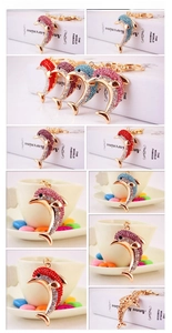 Detail showing dolphin keychains with colorful rhinestones and gold lobster clasps