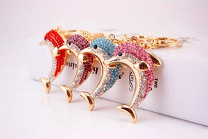 Detailed view of dolphin keychains in red, purple, blue, and pink sparkling rhinestones