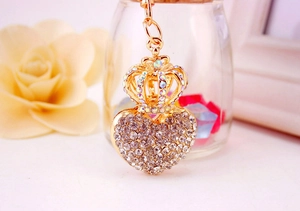 Detailed view of heart-shaped crown keychain with sparkling rhinestones in gold finish