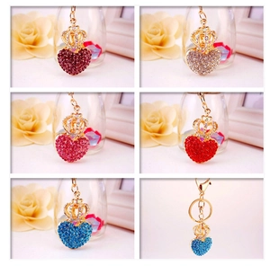 Detail view of heart-shaped crown keychains with colorful rhinestones in five vibrant colors