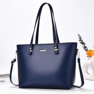 Elegant navy blue leather tote bag with gold hardware and detachable shoulder strap