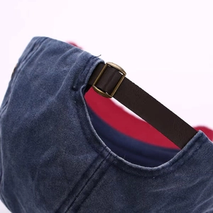 Close-up of vintage denim baseball cap back with leather strap and metal buckle