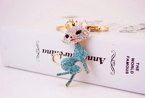 Detailed close-up of a fox metal keychain with inlaid blue and clear rhinestones