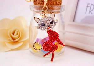 Close-up of sparkling crystal fox keychain with red and silver rhinestones on gold base
