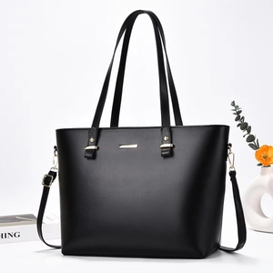 Elegant black minimalist faux leather tote bag with gold hardware and shoulder strap