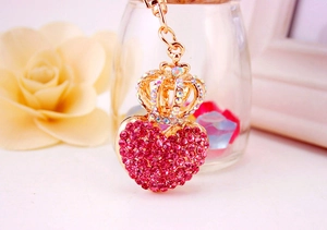Detailed view of golden crown and red heart pendant with sparkling rhinestones keychain