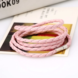 Detailed macro of a pink multi-layer braided PU leather bracelet with a silver magnetic clasp