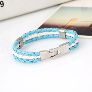 Close-up of woven blue and white faux leather bracelet with silver magnetic metal clasp