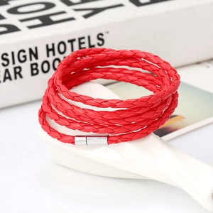 Close-up of red multi-layer braided leather bracelet with silver magnetic metal clasp
