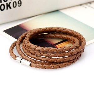 Close-up of brown multi-layer braided leather bracelet with silver magnetic clasp