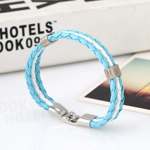 Detail of woven light blue and white PU leather bracelet with silver metal clasp and rings