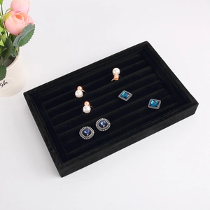 Detailed top view of black velvet jewelry tray for rings and earrings display
