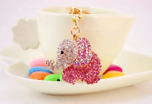 Detailed macro view of a gold elephant keychain with sparkling pink and clear rhinestones
