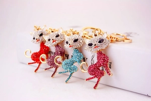 Detail view of crystal-encrusted cat keychains in vibrant red, purple, blue, and pink colors