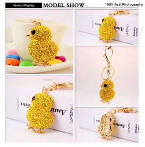 Detail shots of yellow chick keychain with rhinestones and golden hollow metal structure
