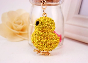 Close-up of a sparkling yellow chick keychain with rhinestones and golden metal hardware