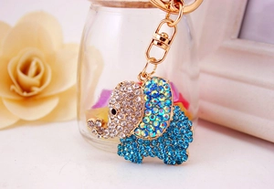 Close-up of a golden elephant keychain with sparkling blue and clear rhinestones
