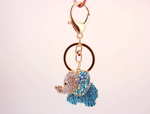 Detailed view of golden elephant keychain with sparkling blue and clear rhinestones