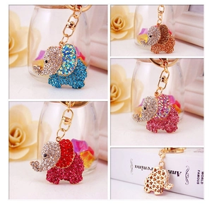 Close-up collage of colorful rhinestone elephant keychains in gold metal finishes