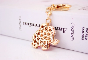 Detail of golden elephant keychain with hollow star patterns and crystal rhinestones