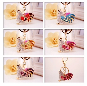Macro shot of rhinestone rooster keychains in multiple vibrant colors for handbags