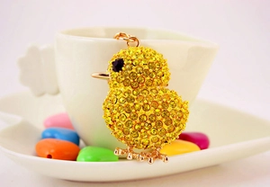 Close-up of yellow chick keychain featuring sparkling golden rhinestones and metal loop
