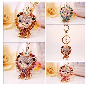 Close-up of cute cartoon lion keychains with sparkling rhinestones in various colors
