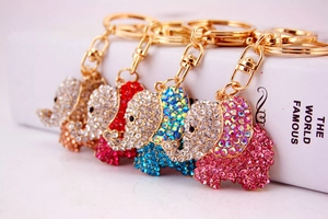 Detail showing five rhinestone elephant keychains in pink, blue, red, white and gold colors