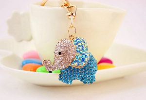 Close-up of golden elephant keychain featuring sparkling blue and clear rhinestones