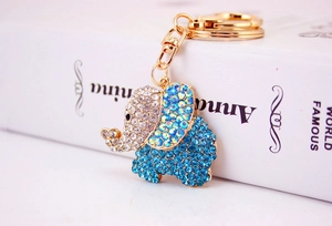 Close-up of golden elephant keychain with sparkling blue and clear rhinestones