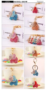 Detailed macro view of crystal elephant keychains with colorful rhinestones in gold setting