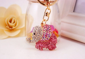 Macro shot of sparkling pink rhinestone elephant keychain with elegant gold-tone metal hardware