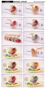 Collection of colorful rhinestone rooster keychains in multiple vibrant color options