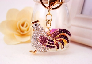 Sparkling rooster keychain with purple gradient rhinestones on golden metal base