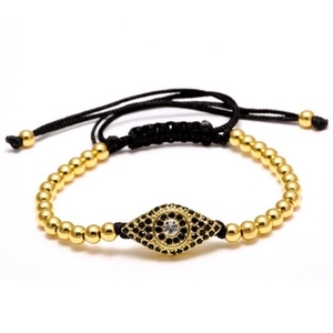 Detail of evil eye charm bracelet with black rope, gold beads and sparkling zircon stones