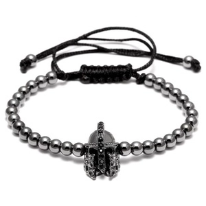 Detail of woven bracelet with black gold stone beads and Spartan helmet charm