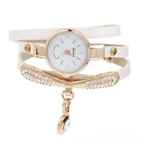 Detail view of multi-layer white leather strap watch with rose gold rhinestones
