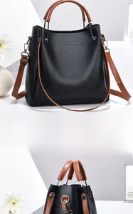 Vue détaillée du sac cabas en cuir noir à motif litchi avec anses brunes et détails en métal