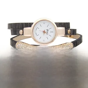 Detail of a wrap-around ladies watch with black snake skin leather strap and crystals