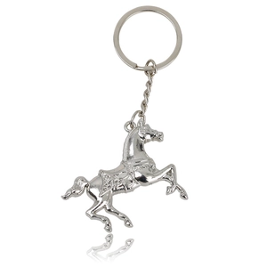 Polished silver metal horse keychain with leaping stallion pendant and ring on white background