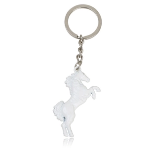 Detail of creative horse-shaped keychain with white enamel finish and silver metal ring