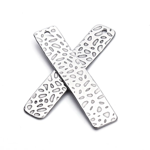 Detailed view of silver rectangular hammered metal charms for DIY jewelry making