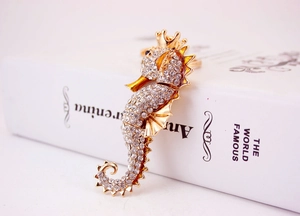 Detailed close-up of a seahorse keychain with sparkling rhinestones on golden metal